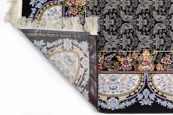 A close-up of a Qaleen Carpets rug's corner, showcasing its intricate design and rich colors