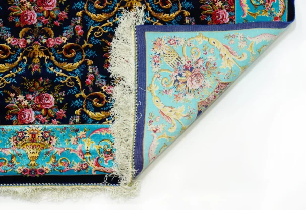A close-up of a Qaleen Carpets rug's corner, showcasing its intricate design and rich colors
