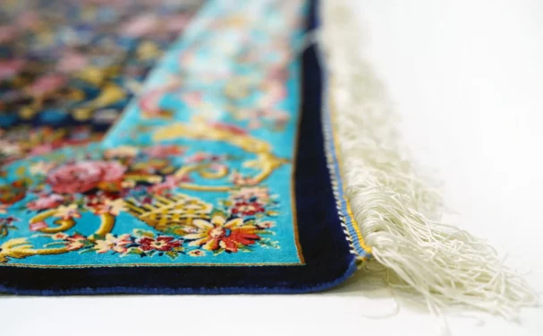 Qaleen Carpets A close-up of a vibrant, intricately designed Qaleen Carpet, showcasing its rich colors and patterns