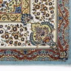A close-up of a Qaleen Carpets rug with intricate floral patterns and a border, showcasing the company's high-quality and