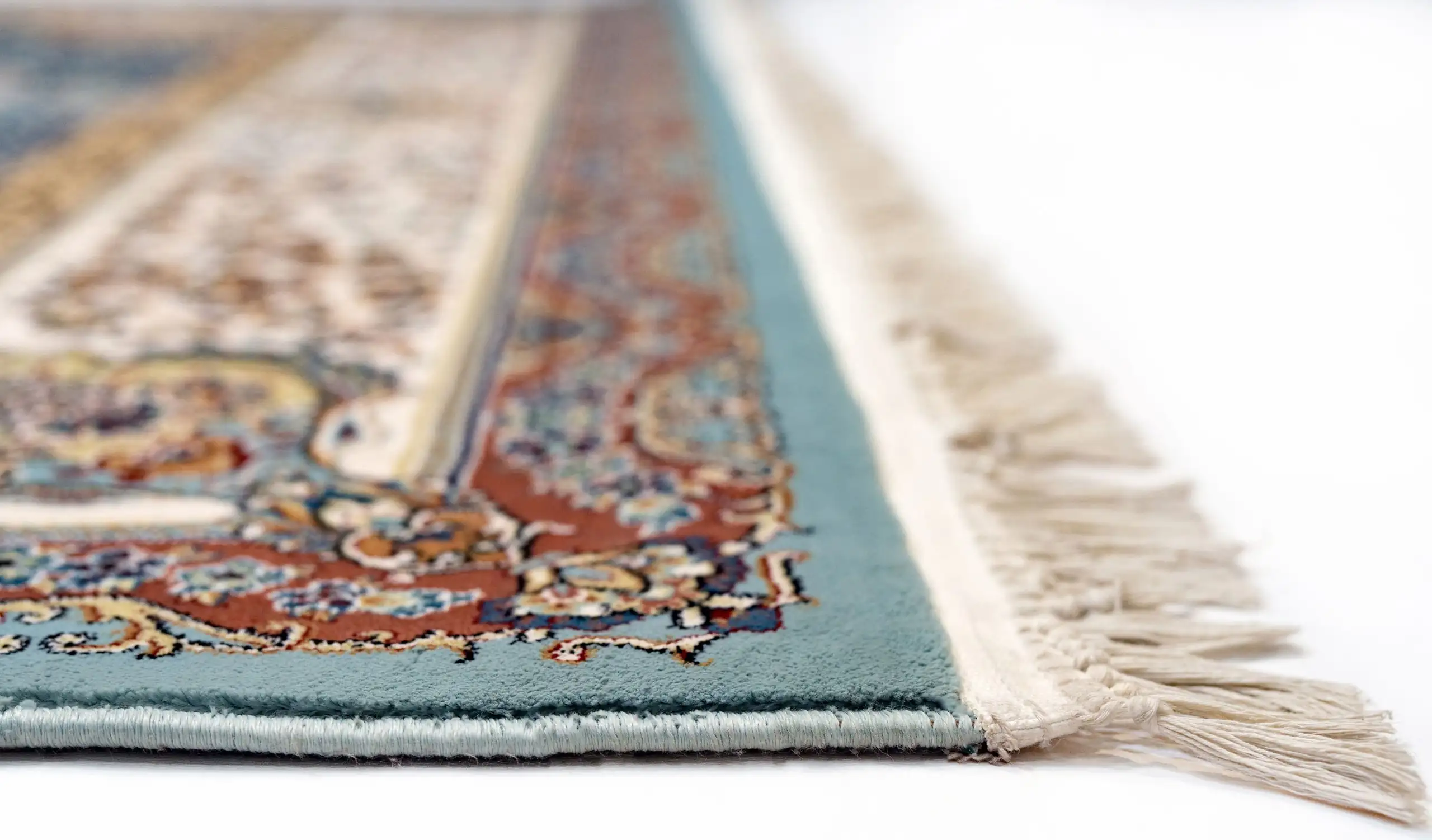 A close-up of a Qaleen Carpets rug, showcasing its intricate patterns and vibrant colors