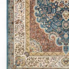 A close-up of a Qaleen Carpets rug with intricate patterns and colors, showcasing its unique design and quality