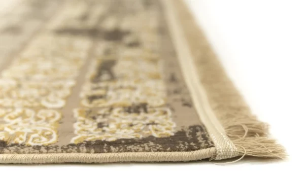 A close-up of the edge of a Qaleen Carpets rug, with a focus on the intricate design and the soft, frayed edge