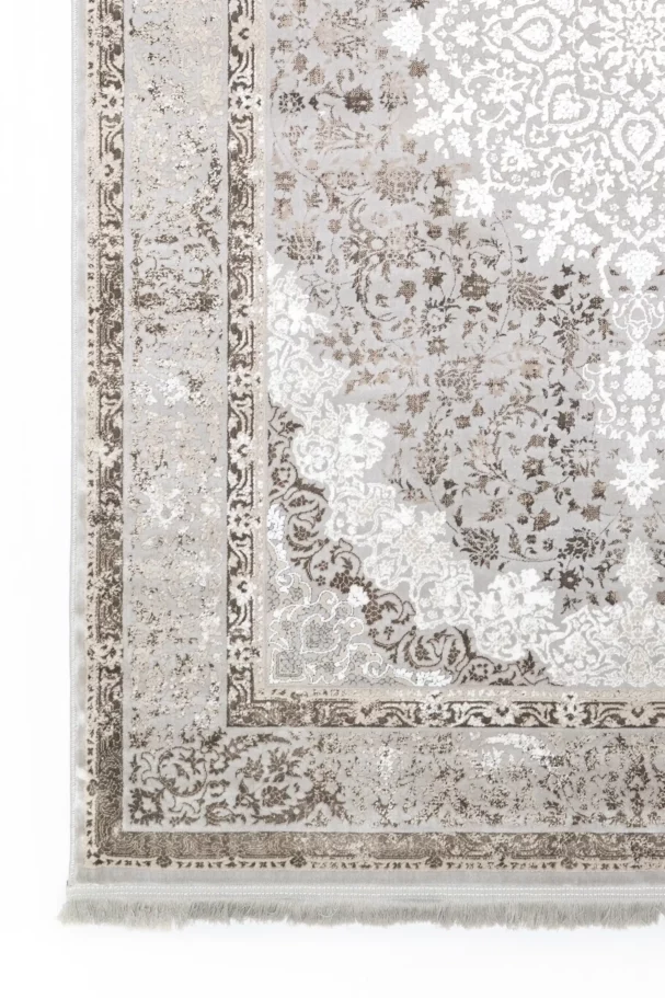 A close-up of a Qaleen Carpets rug with a floral pattern and intricate design, showcasing its beauty and craftsmanship