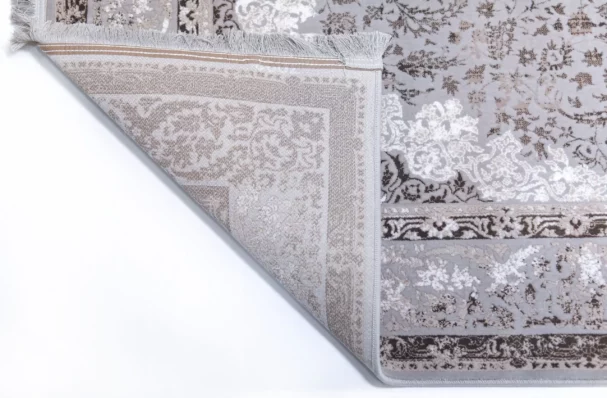 A close-up of a rug's corner, showcasing its intricate patterns and Qaleen Carpets' quality