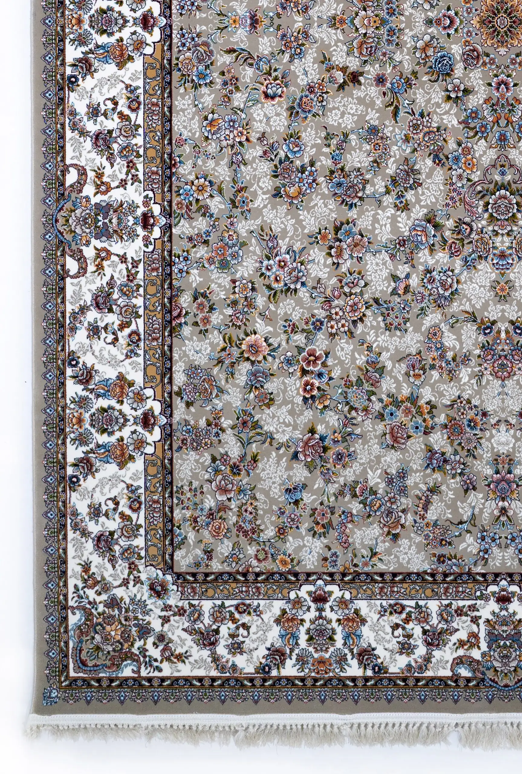 A close-up of a Qaleen Carpets rug with a floral pattern, featuring a mix of flowers and leaves in various colors on a