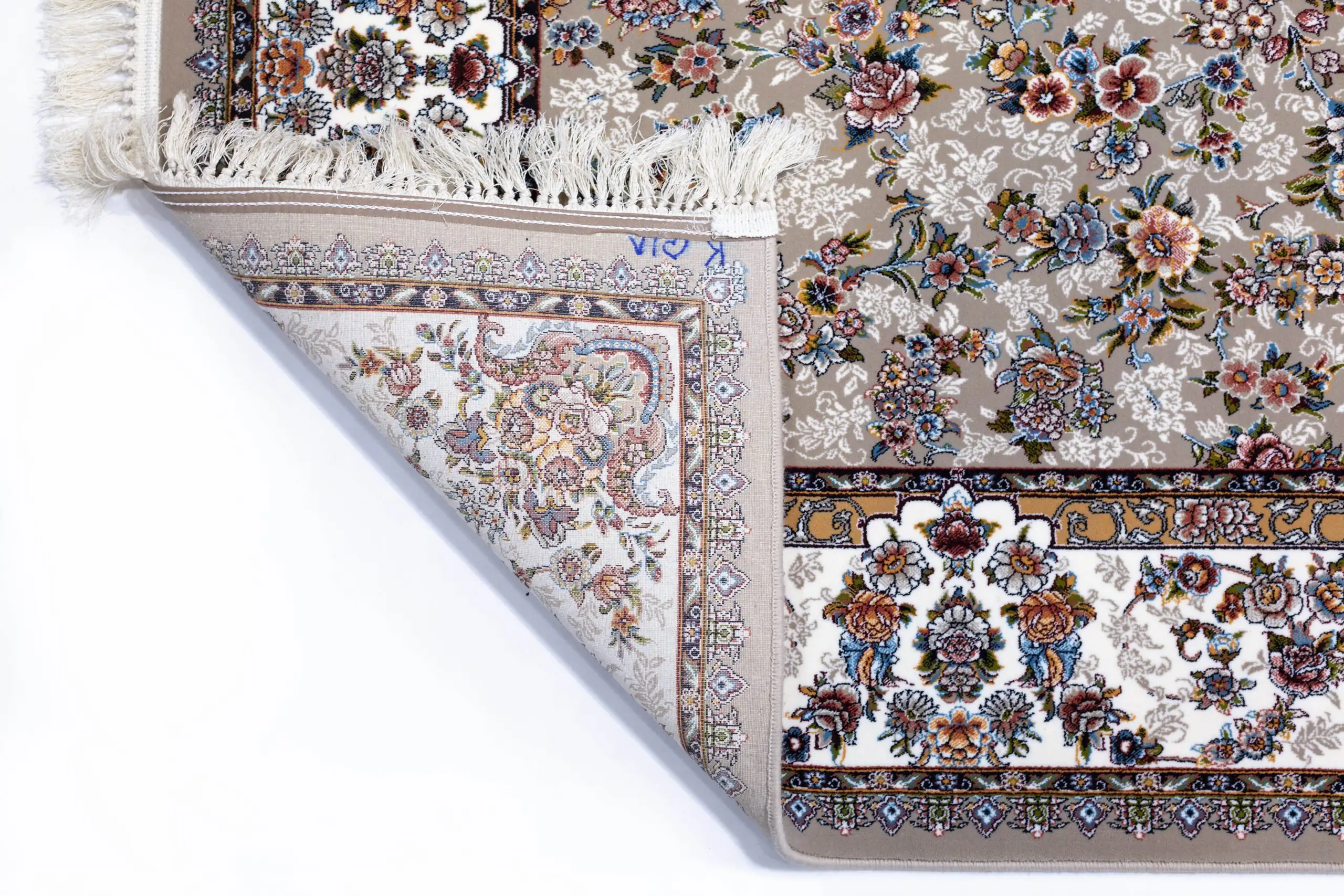 A close-up of a Qaleen Carpets rug with a floral pattern, featuring a mix of flowers and leaves in various colors, with a
