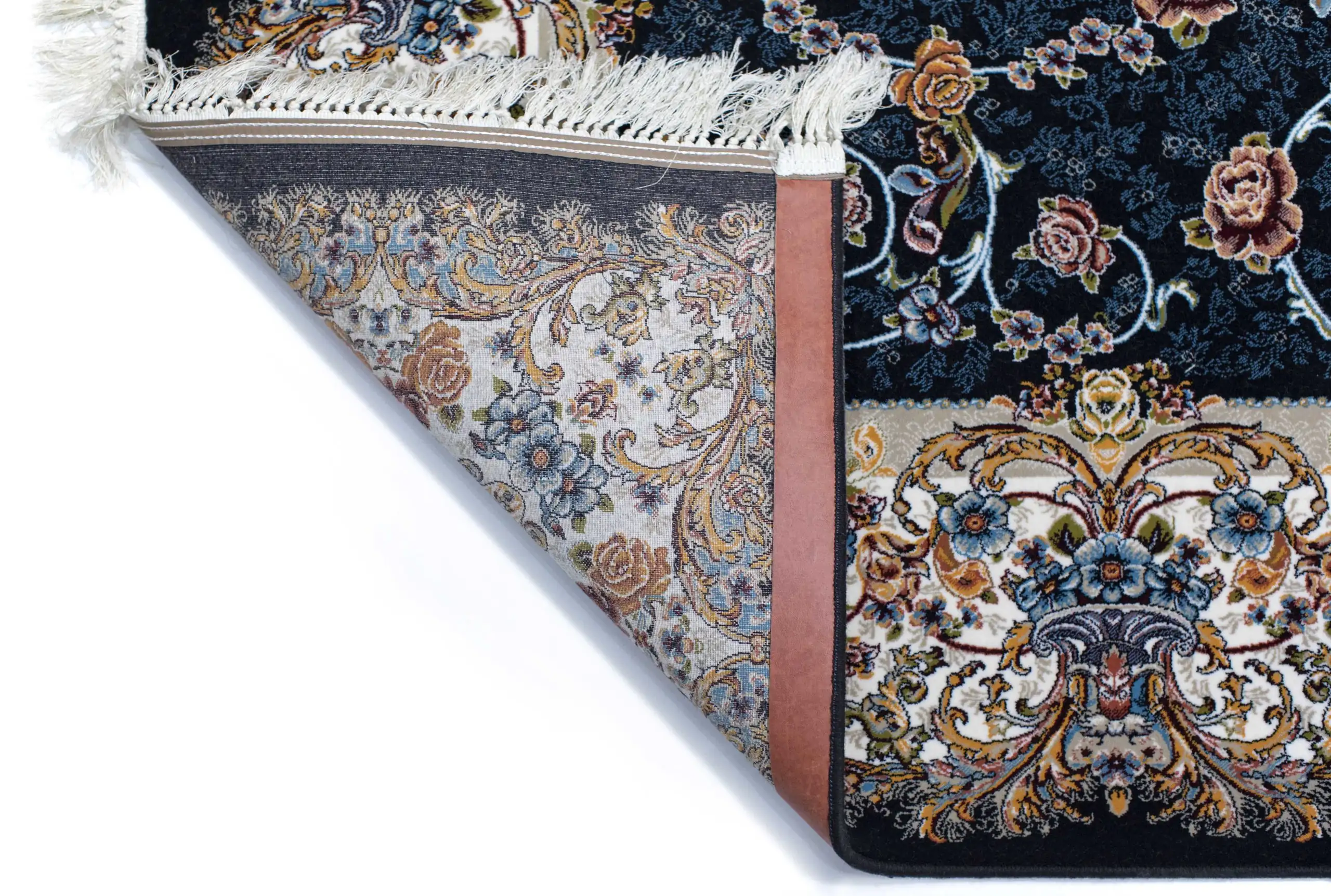 A close-up of a Qaleen Carpets rug with a floral pattern, featuring a mix of blue, gold, and white colors, with a fringe on