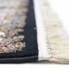 A close-up of a Qaleen Carpets rug, showcasing its intricate design and rich colors