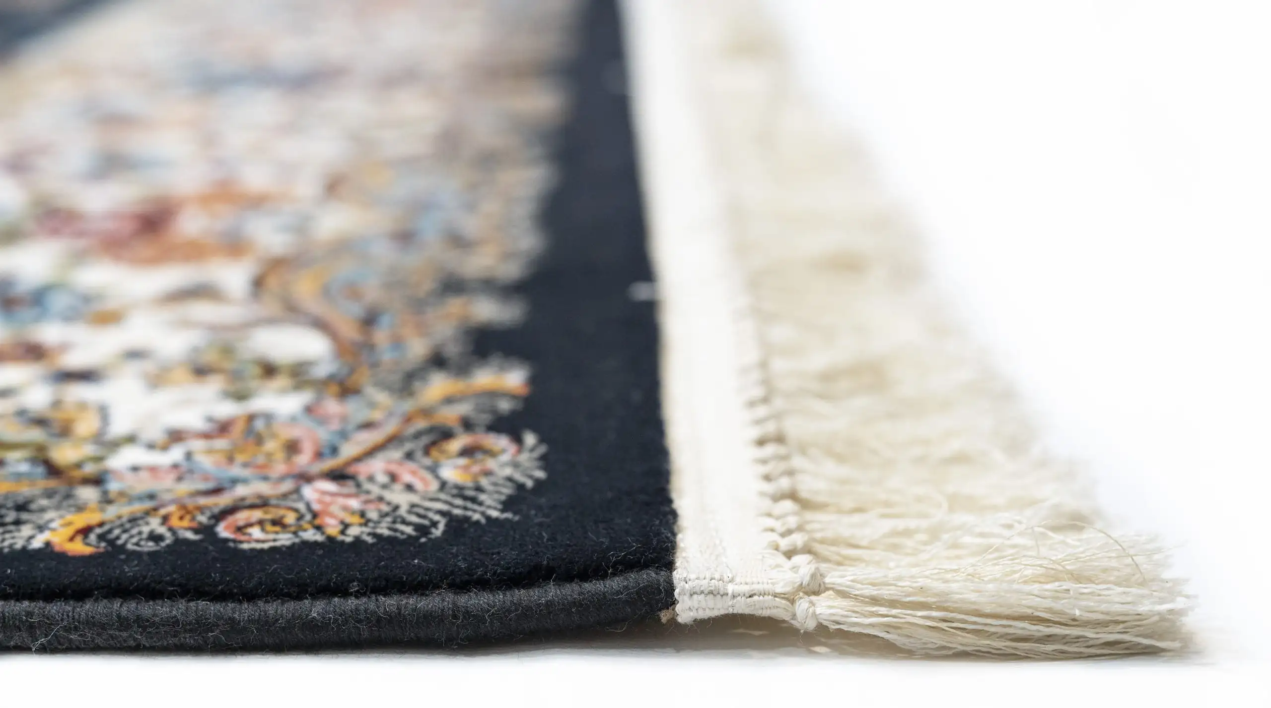 A close-up of a Qaleen Carpets rug, showcasing its intricate design and rich colors