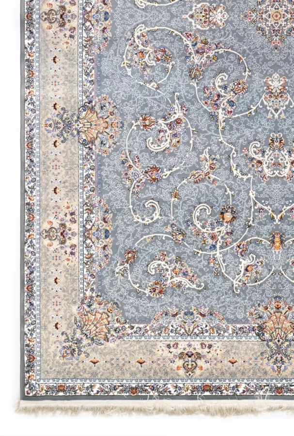 A close-up of a Qaleen Carpets rug with a grey and cream patterned design, featuring intricate floral and vine motifs, set
