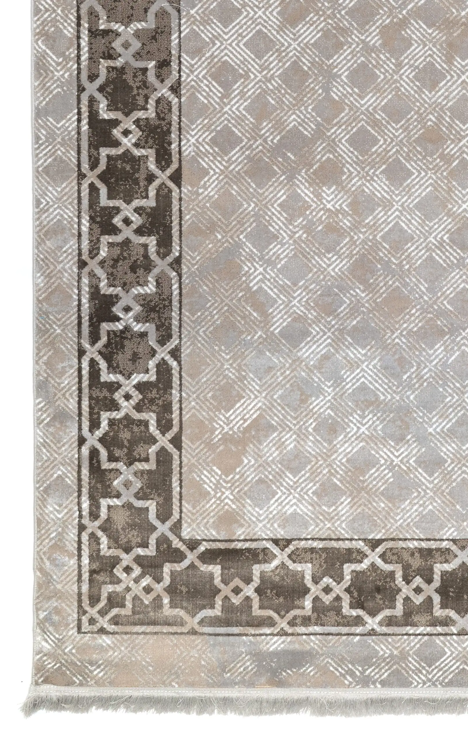 A close-up of a Qaleen Carpets rug with a geometric pattern and a border, showcasing the intricate design and quality of the