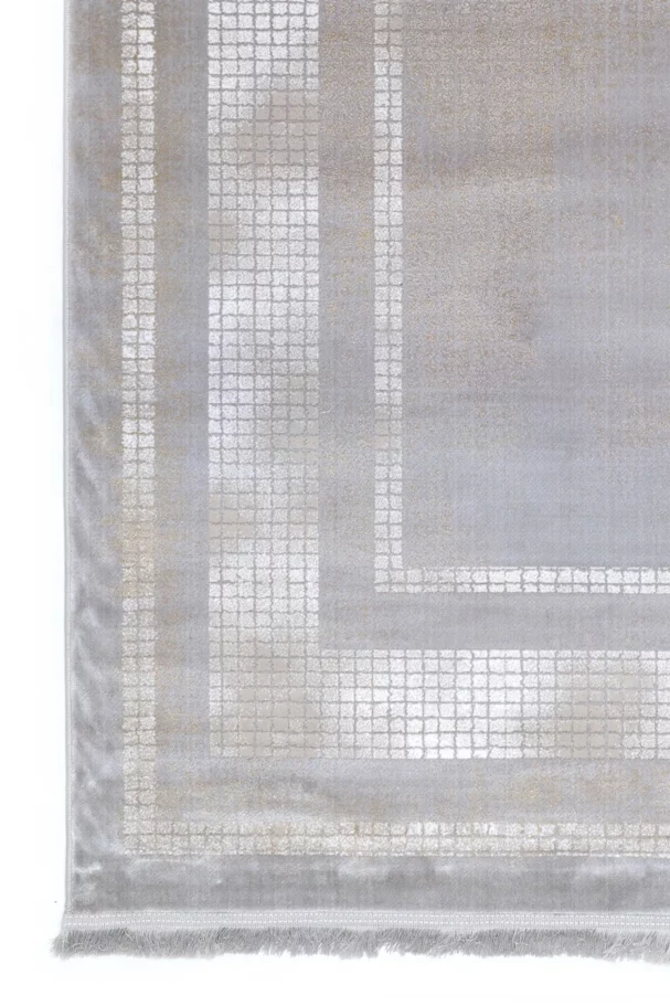 A close-up of a Qaleen Carpets rug with a geometric pattern, featuring a mix of light and dark grey hues, with a subtle