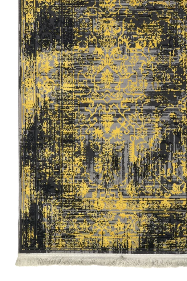 A close-up of a Qaleen Carpets rug with a black and gold pattern, featuring a mix of traditional and modern elements, with a