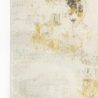 A close-up of a Qaleen Carpets rug with a cream and gold design, featuring a subtle, intricate pattern and a soft, luxurious
