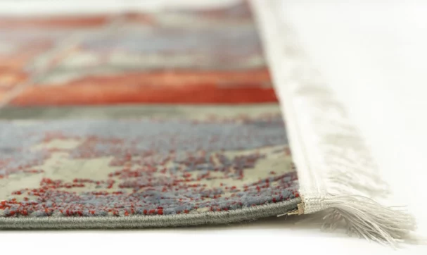 A close-up view of a Qaleen Carpets rug, showcasing its intricate patterns and colors