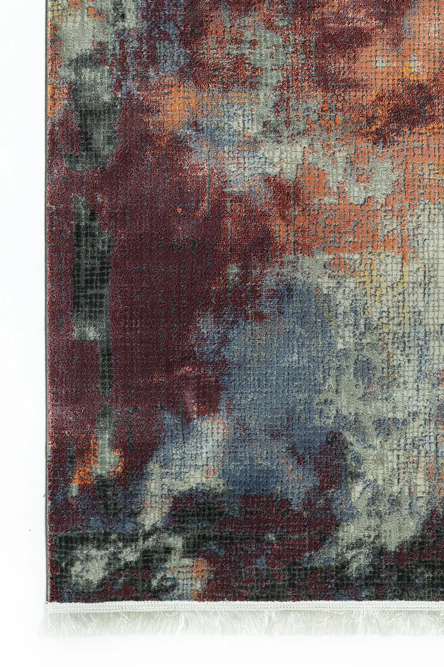 A close-up of a Qaleen Carpets rug with a mix of red, blue, and white colors, featuring a unique blend of patterns and
