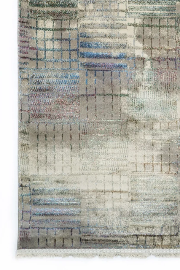 A close-up of a Qaleen Carpets rug with a unique, intricate design, featuring a mix of colors and patterns, showcasing the