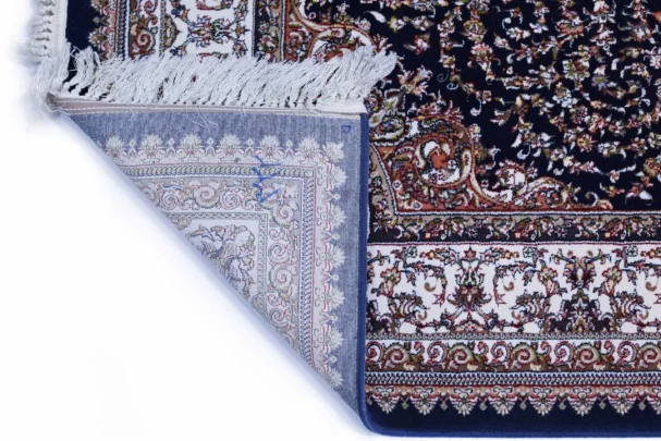 Carpets A close-up of a rug's corner, showcasing its intricate carpet design and delicate carpeting