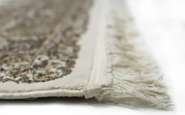 A close-up of a Qaleen Carpets rug's intricate, hand-knotted design, showcasing its beauty and craftsmanship