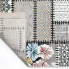 Carpets A close-up of a rug's edge, with a pattern of flowers and a border of intricate designs, showcasing the quality of