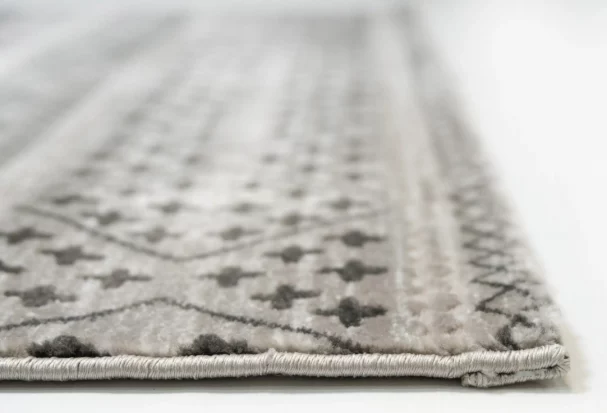 A close-up of a Qaleen Carpets rug's edge, showcasing its intricate design and soft, plush texture