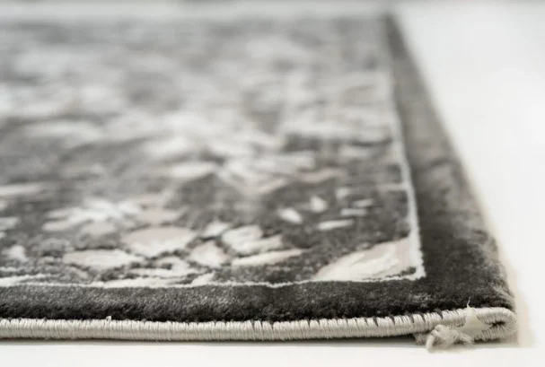 Carpets A close-up of a carpet's edge, showcasing its intricate design and texture