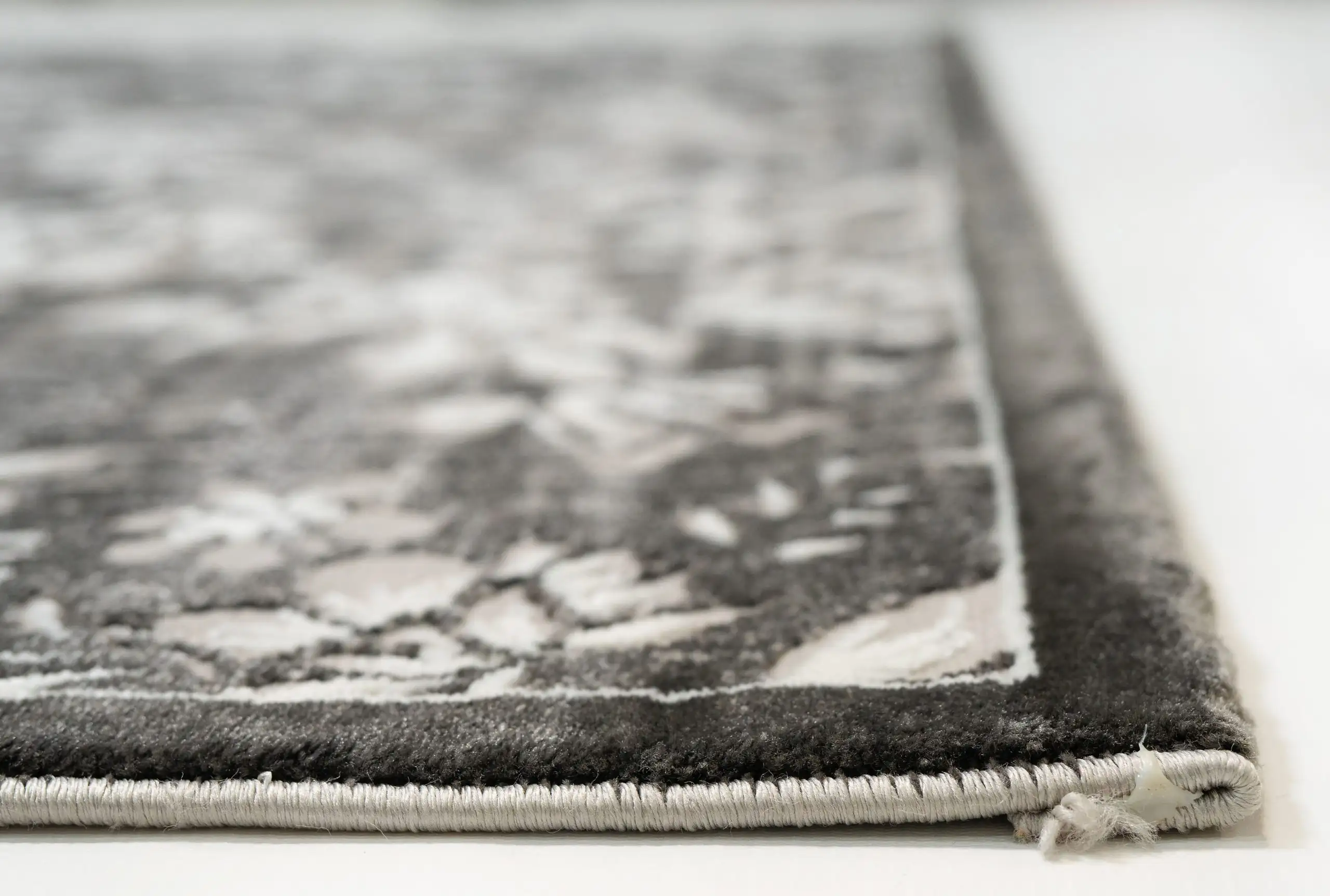 Carpets A close-up of a carpet's edge, showcasing its intricate design and texture