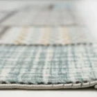 A close-up of a rug's edge, with a focus on its intricate weaving and Qaleen Carpets' quality