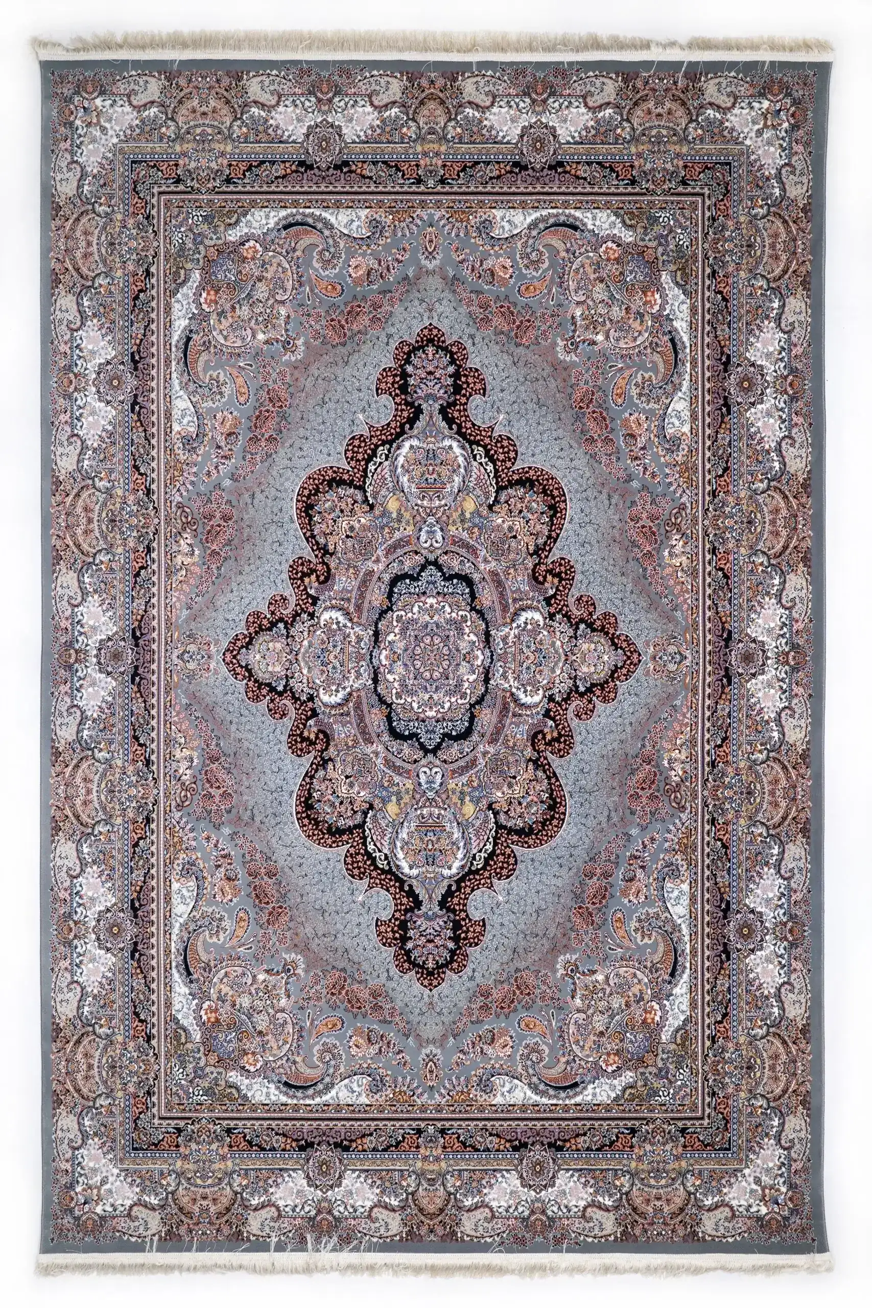 A Qaleen Carpets rug with a central, intricate design and a border of similar patterns, set against a light grey background