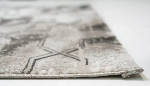 A close-up of a Qaleen Carpets rug, with a focus on its intricate design and texture, showcasing its high-quality and unique