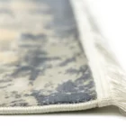 A close-up of a Qaleen Carpets rug's edge, showcasing its intricate design and soft, white fringe