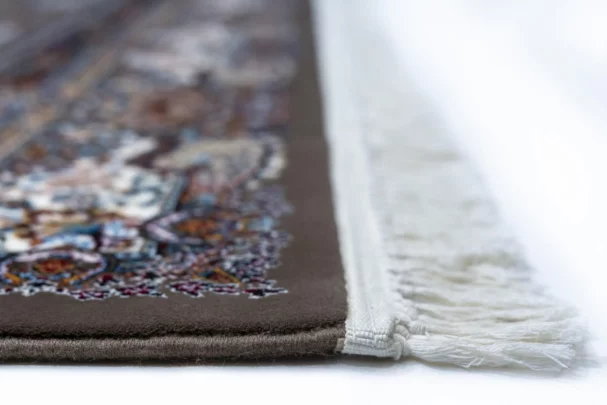 A close-up view of a Qaleen Carpets rug, showcasing its intricate design and rich colors