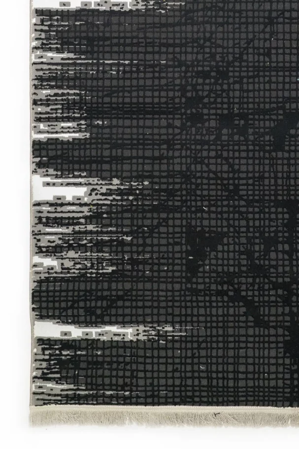Carpets A close-up of a dark grey carpet with a subtle, intricate pattern, showcasing its texture and design