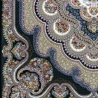 A close-up of a Qaleen Carpets rug, featuring intricate patterns and colors