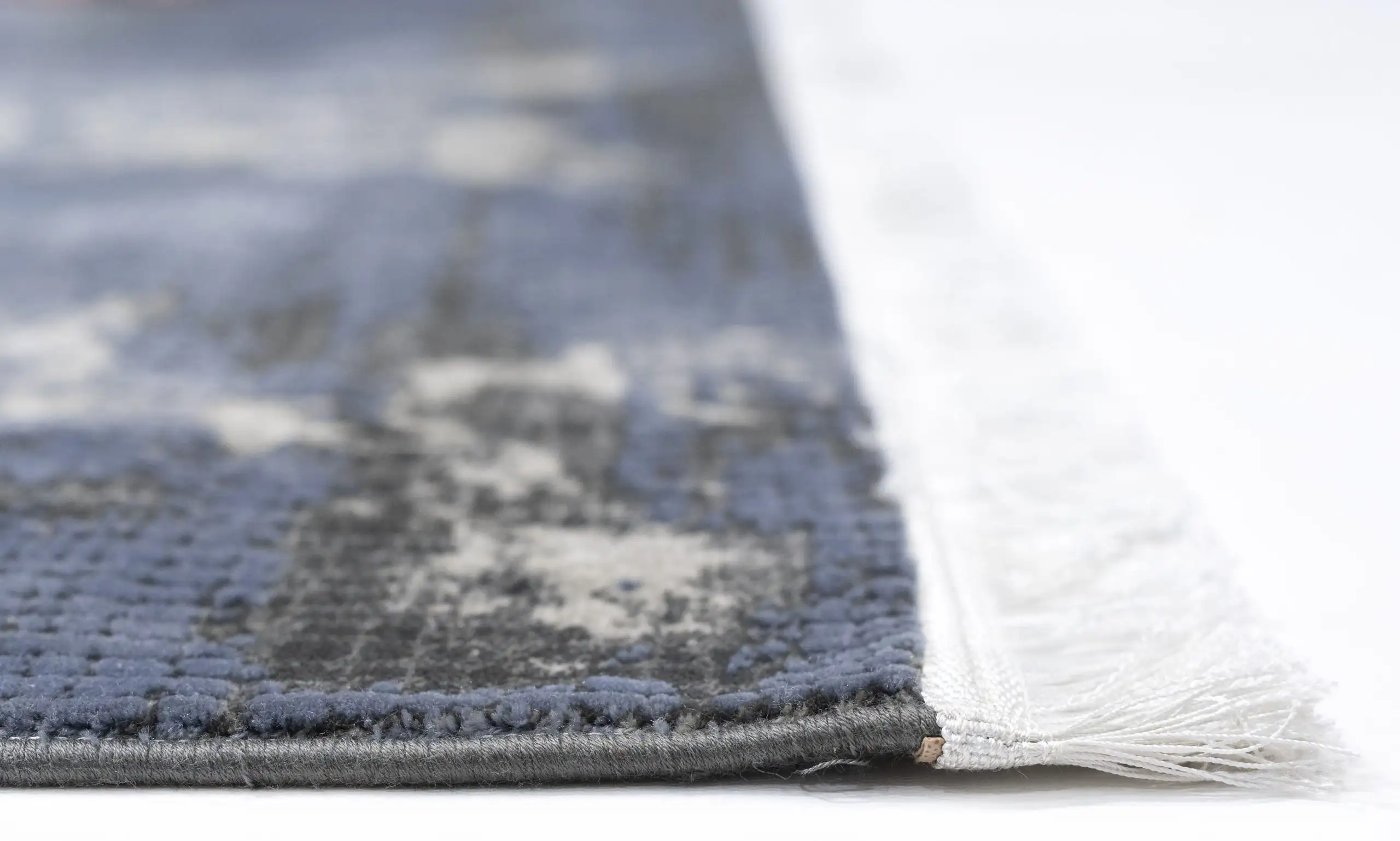 Carpets A close-up of a carpet's edge, with a focus on the carpet's texture and the edge's fringing