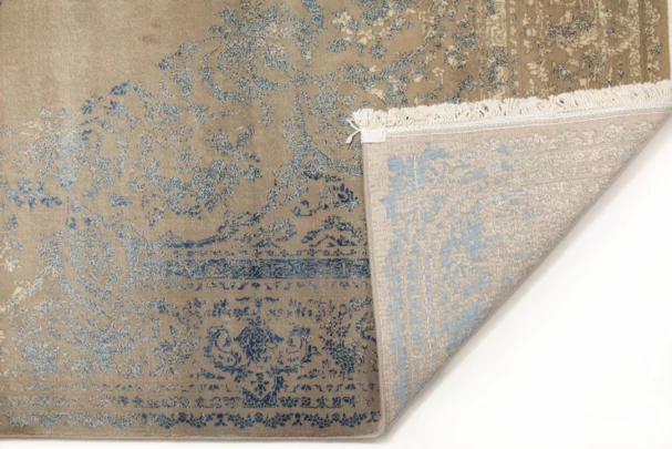 Carpets A beautiful, intricately designed carpet with a mix of blue and beige colors, featuring a classic, timeless pattern