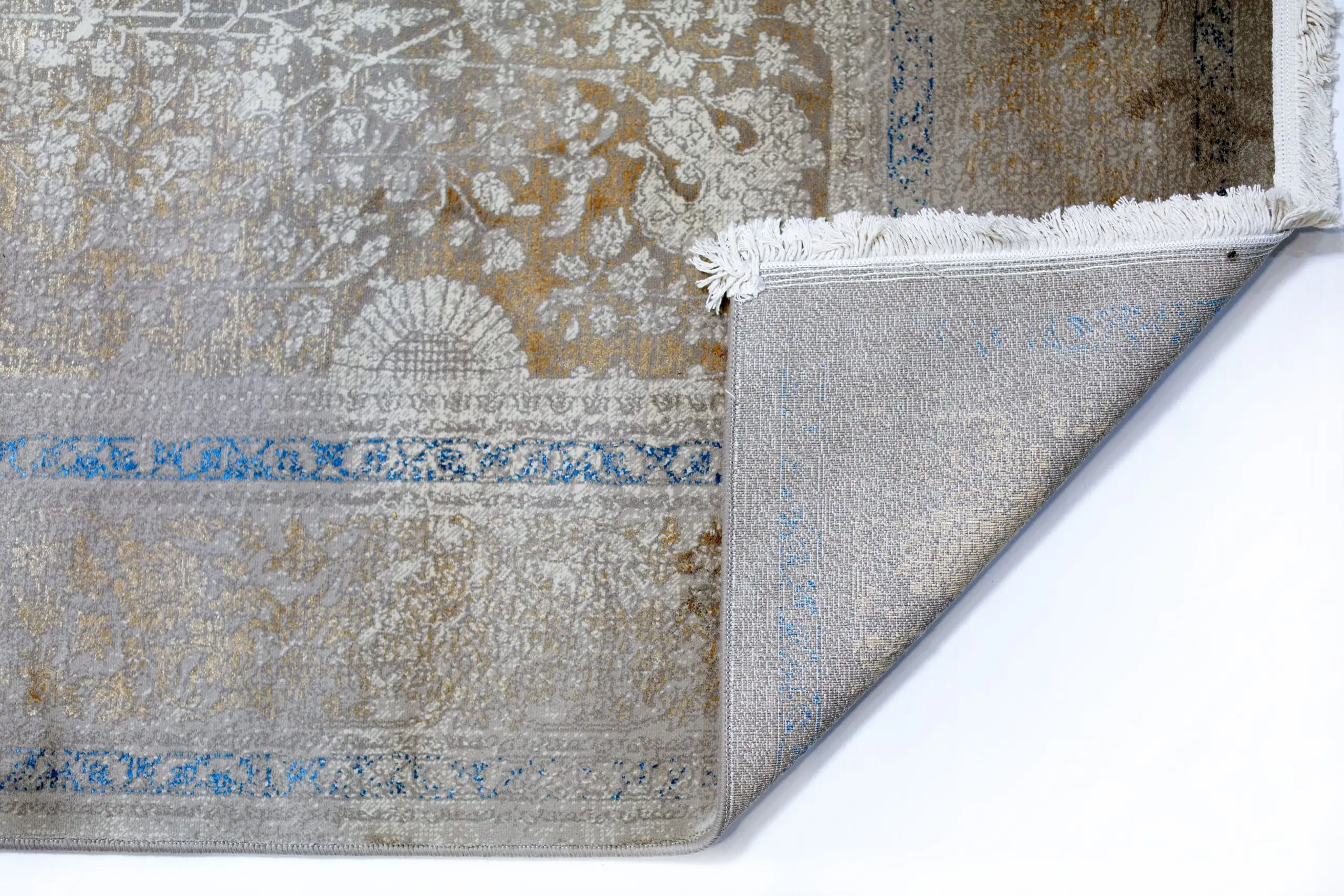 Qaleen Carpets' stunning rug with a mix of gold, blue, and white colors