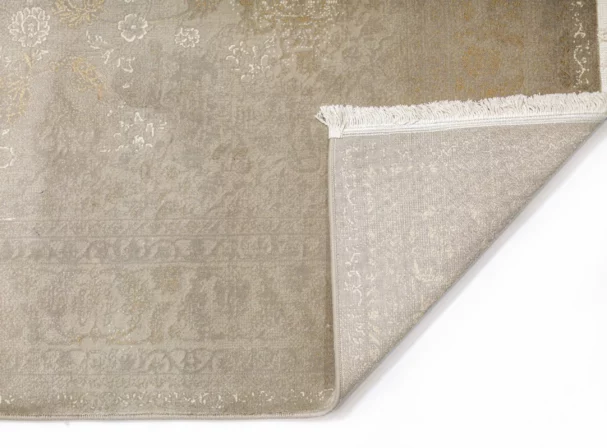 Carpets A beige and gold patterned rug with a subtle, intricate design