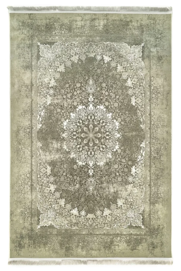 A Qaleen Carpets rug with a distressed, vintage-inspired design in muted green and cream tones, featuring a central
