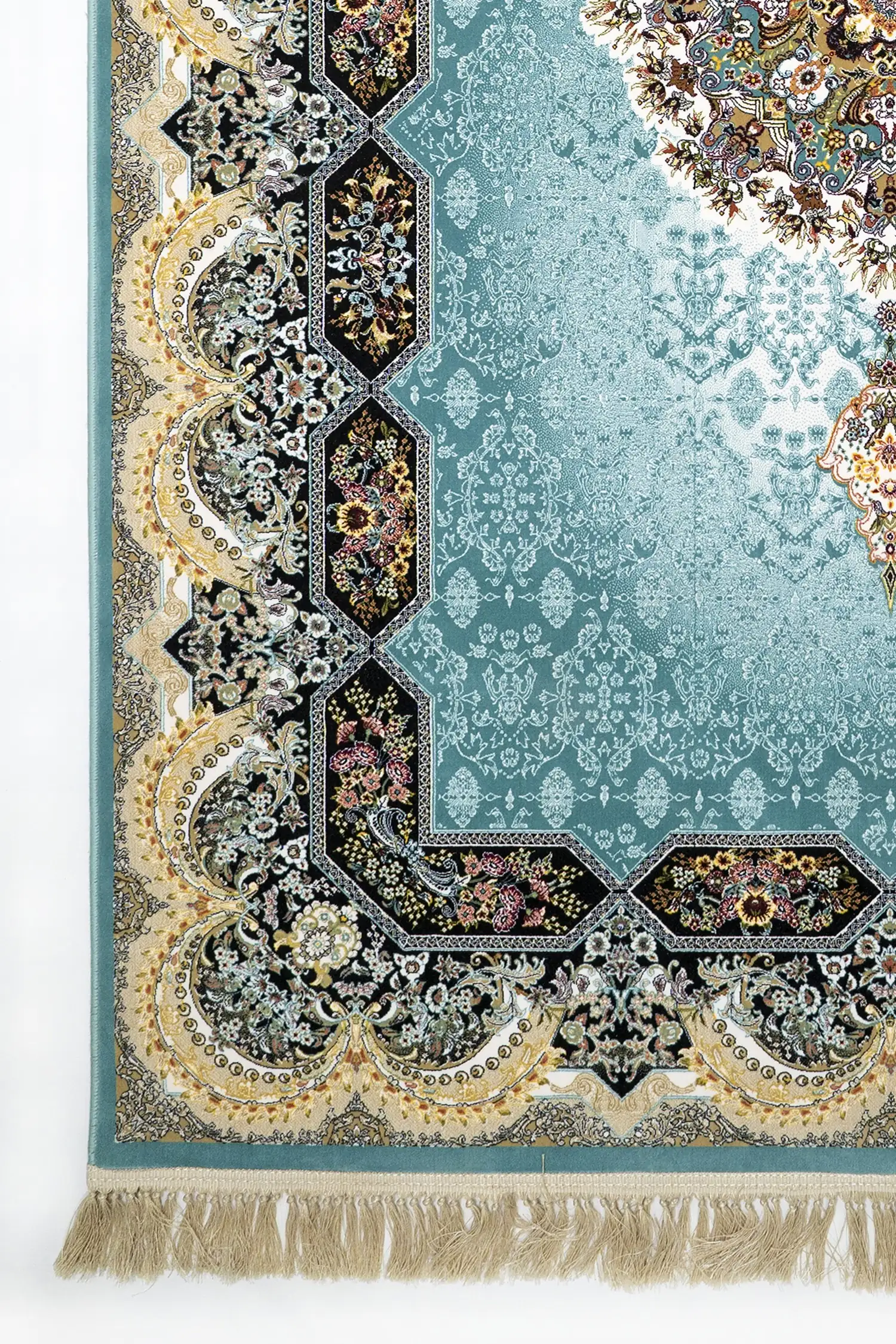 A close-up of a Qaleen Carpets rug with a blue and gold pattern, featuring a central hexagonal design and a border of