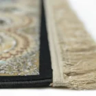 A close-up view of a Qaleen Carpets rug, focusing on its intricate design and fringe, with a focus on its quality and