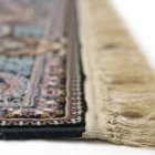 A close-up shot of a Qaleen Carpets rug, focusing on its intricate patterns and fringes
