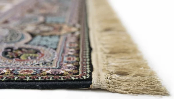 A close-up shot of a Qaleen Carpets rug, focusing on its intricate patterns and fringes