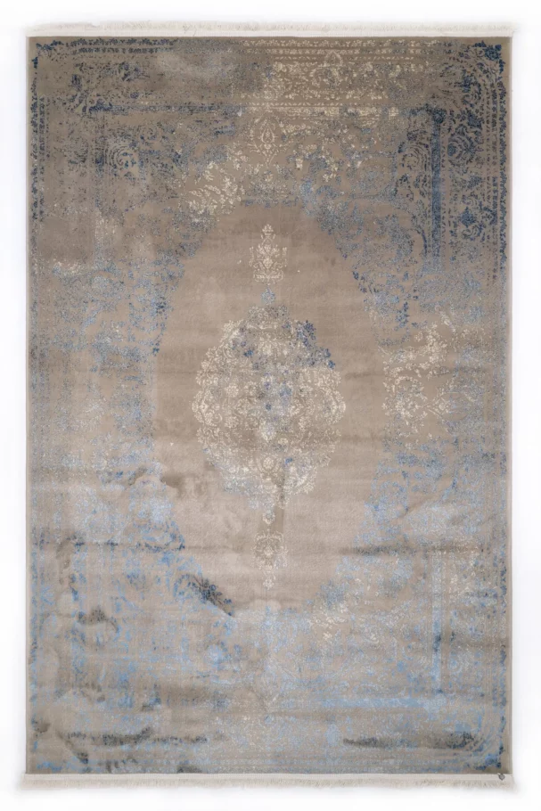 A Qaleen Carpets rug with a distressed, vintage-inspired design in a neutral color palette, featuring a central medallion