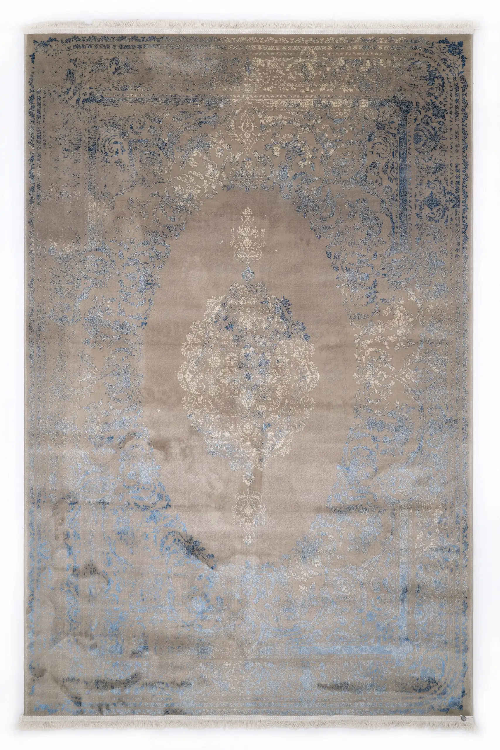 A Qaleen Carpets rug with a distressed, vintage-inspired design in a neutral color palette, featuring a central medallion