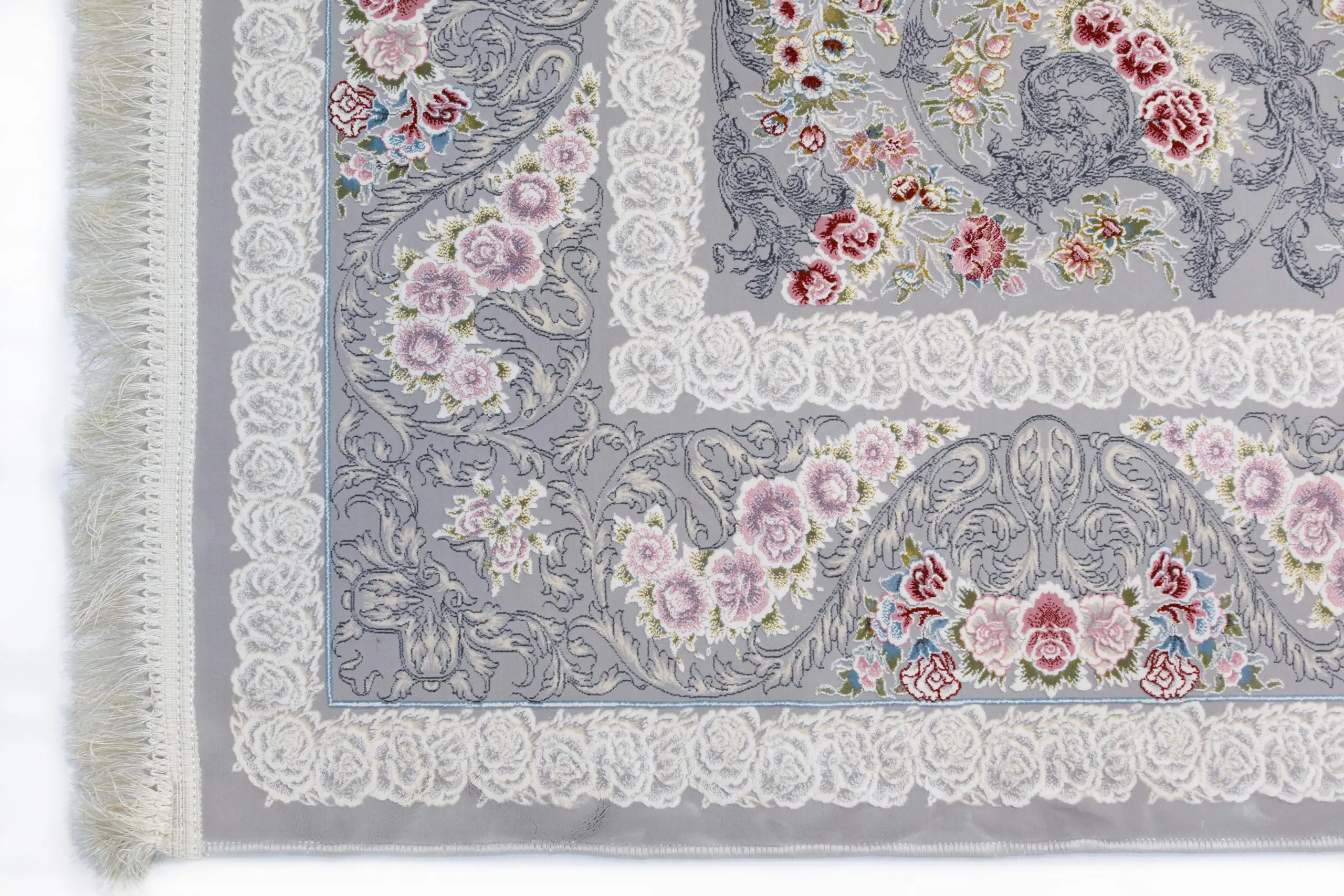 A close-up of a gray rug with a white border and intricate floral patterns, made by Qaleen Carpets