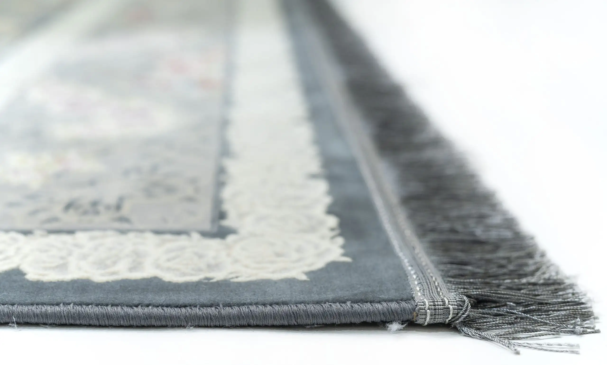 Carpets A close-up of a carpet's edge, with a focus on the intricate design and the soft, fluffy texture of the carpet's edge
