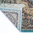 A Qaleen Carpets rug with a mix of floral and geometric patterns, featuring a mix of pastel and earthy colors, with a fringe