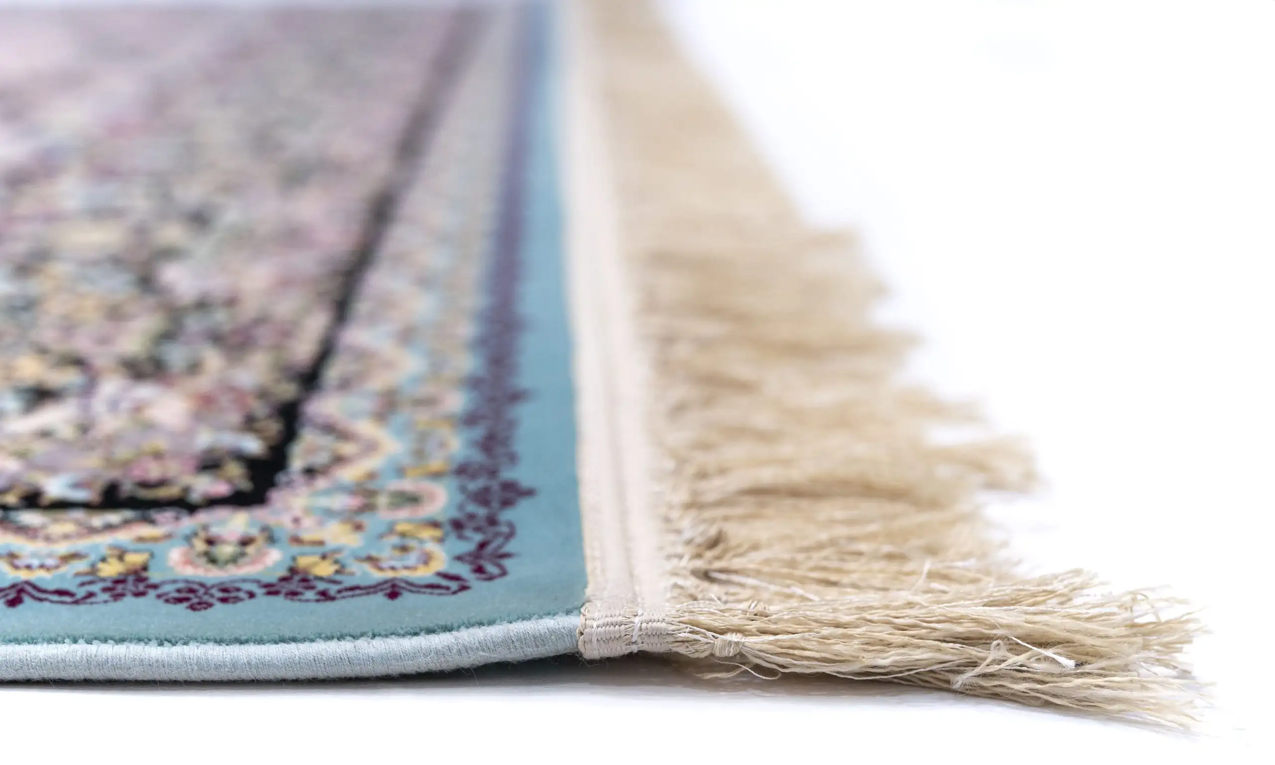 Carpets A close-up of a rug's edge, with a soft, intricate pattern and a delicate, soft-looked fringe